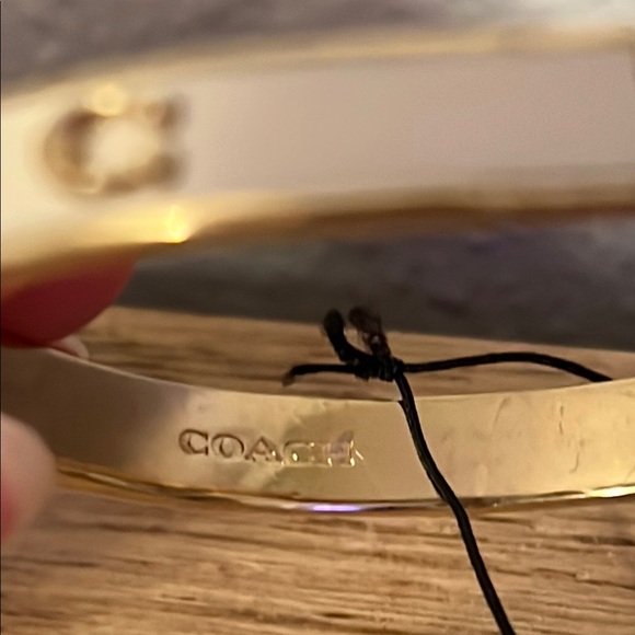 Coach Gold and White Bracelet. Has small crack in white paint on one side. - Picture 5 of 6